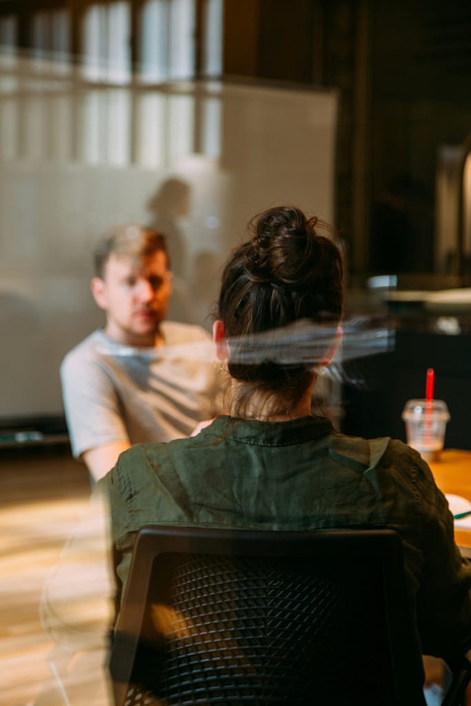 An M&A consultant conducting an operational diagnostic interview with a business stakeholder in a private corporate office room.